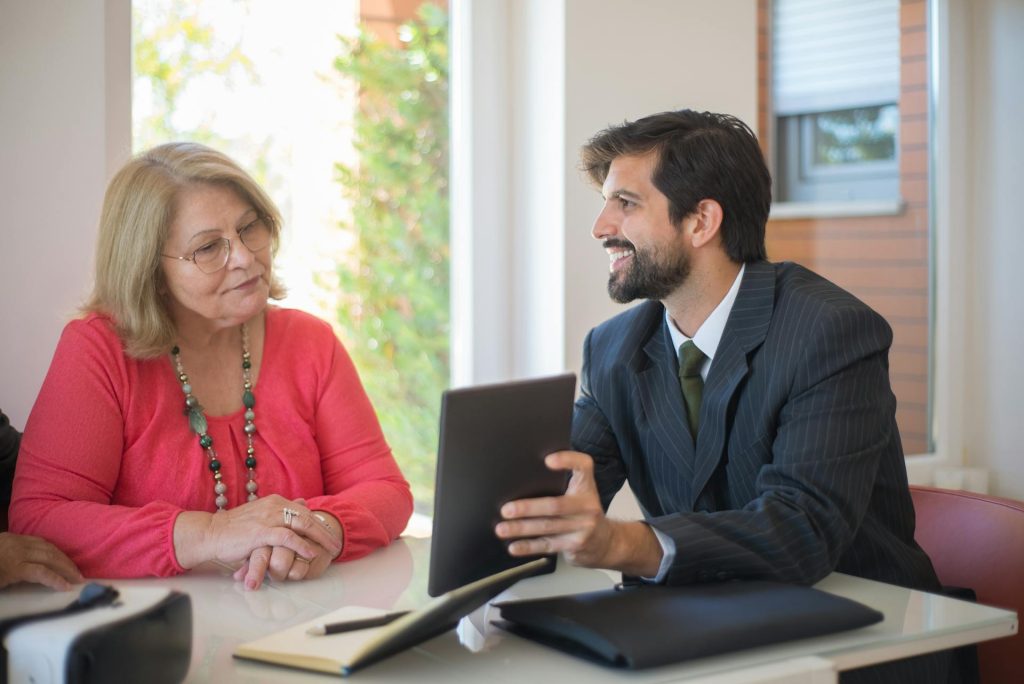 Business professionals discussing regulatory compliance guidance at a desk