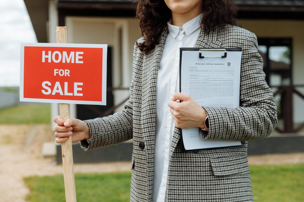 Real estate agent holding Home for Sale sign and clipboard for property media optimization